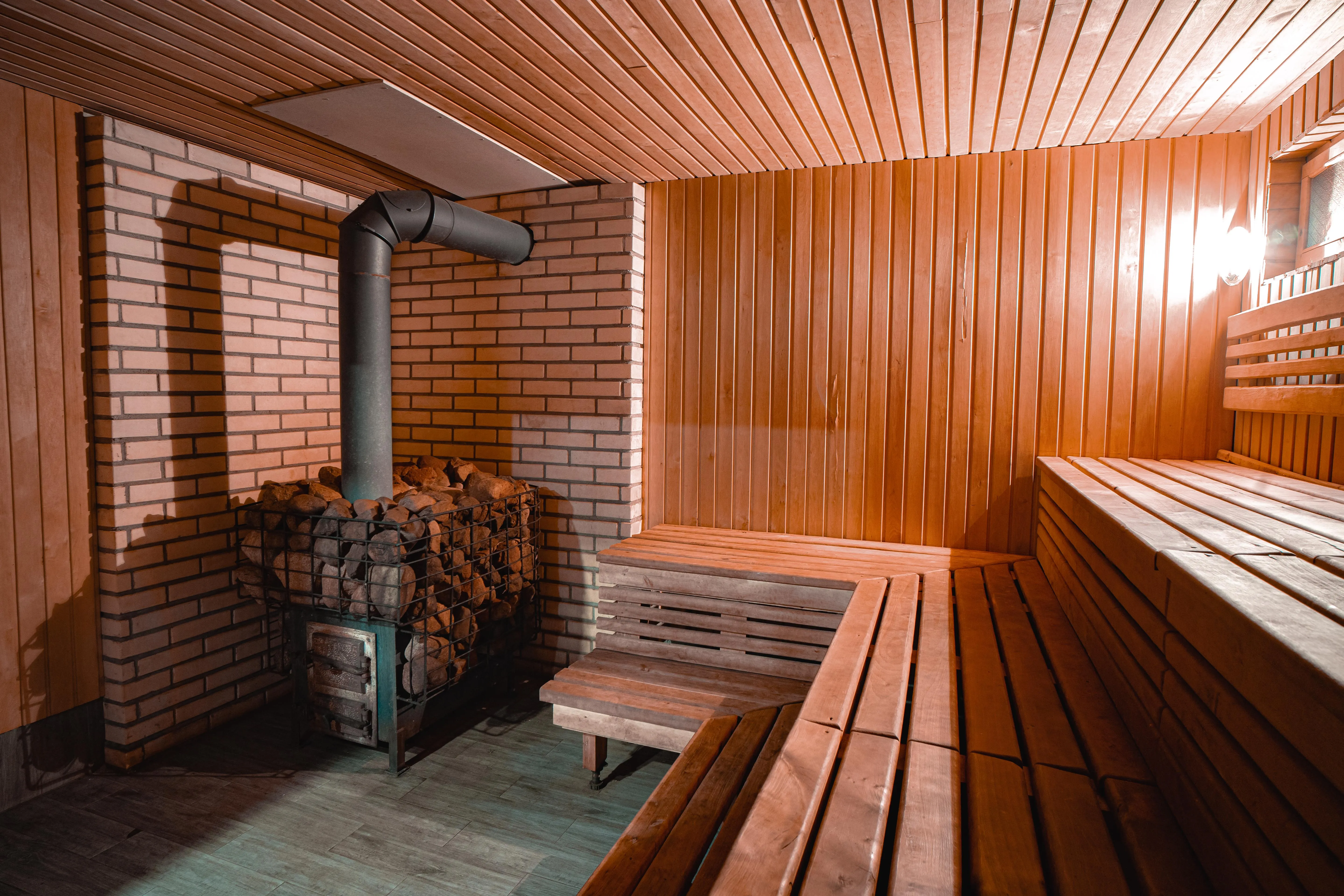 Pirtis — medinė sauna su akmenine virš liepsnomis, šiltas ir gyvai atmosfera